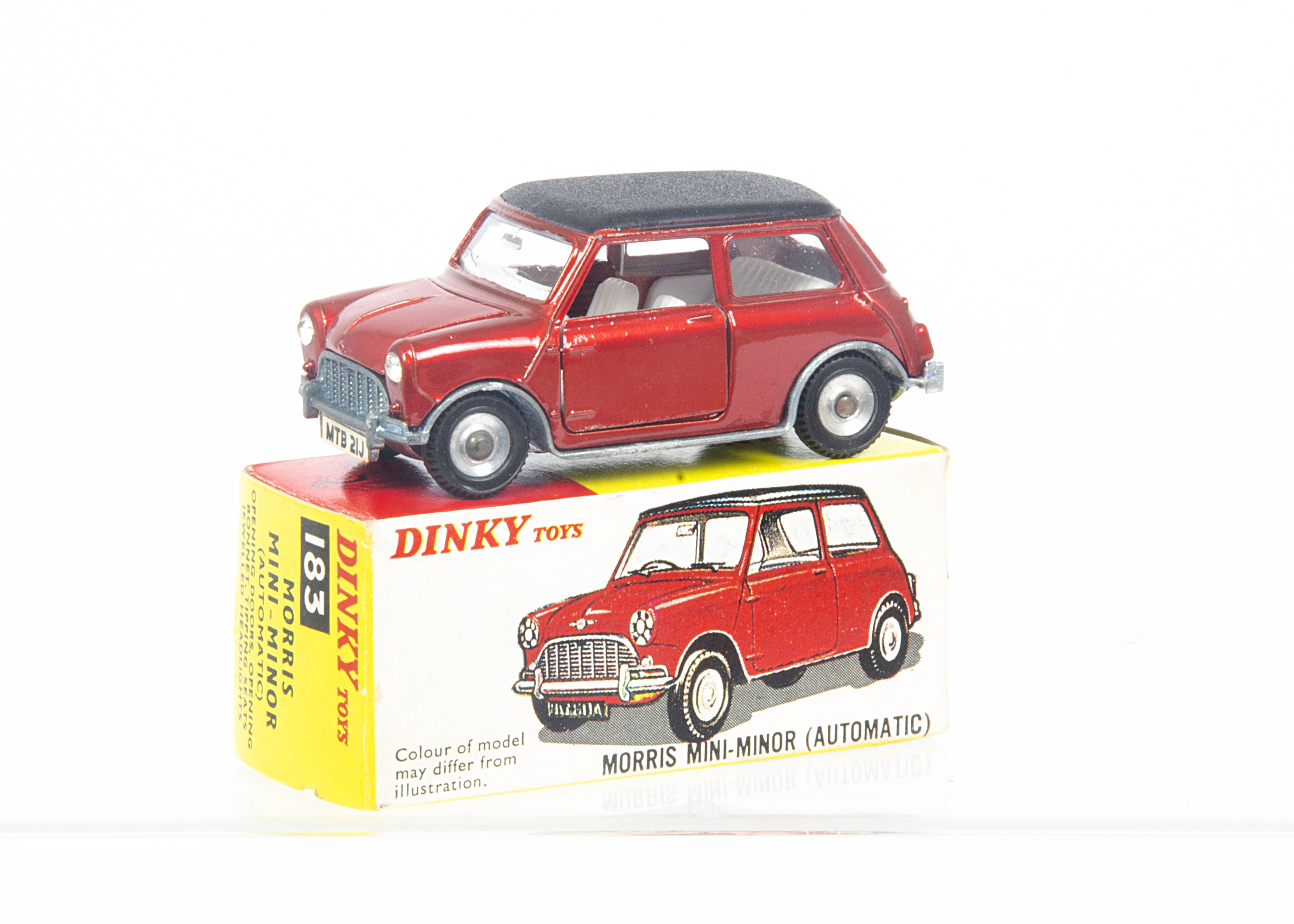 A Dinky Toys 183 Morris Mini Minor, metallic red body, matt black roof, white interior, spun hubs,
