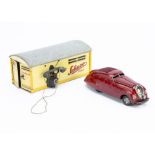 A 1930s Schuco Tinplate Clockwork Kommando Anno 2000 Car, maroon body, spun hubs, with No 1500