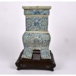 A Chinese vase of block form raised on fu legs, this shape after bronze vessels with a squared and