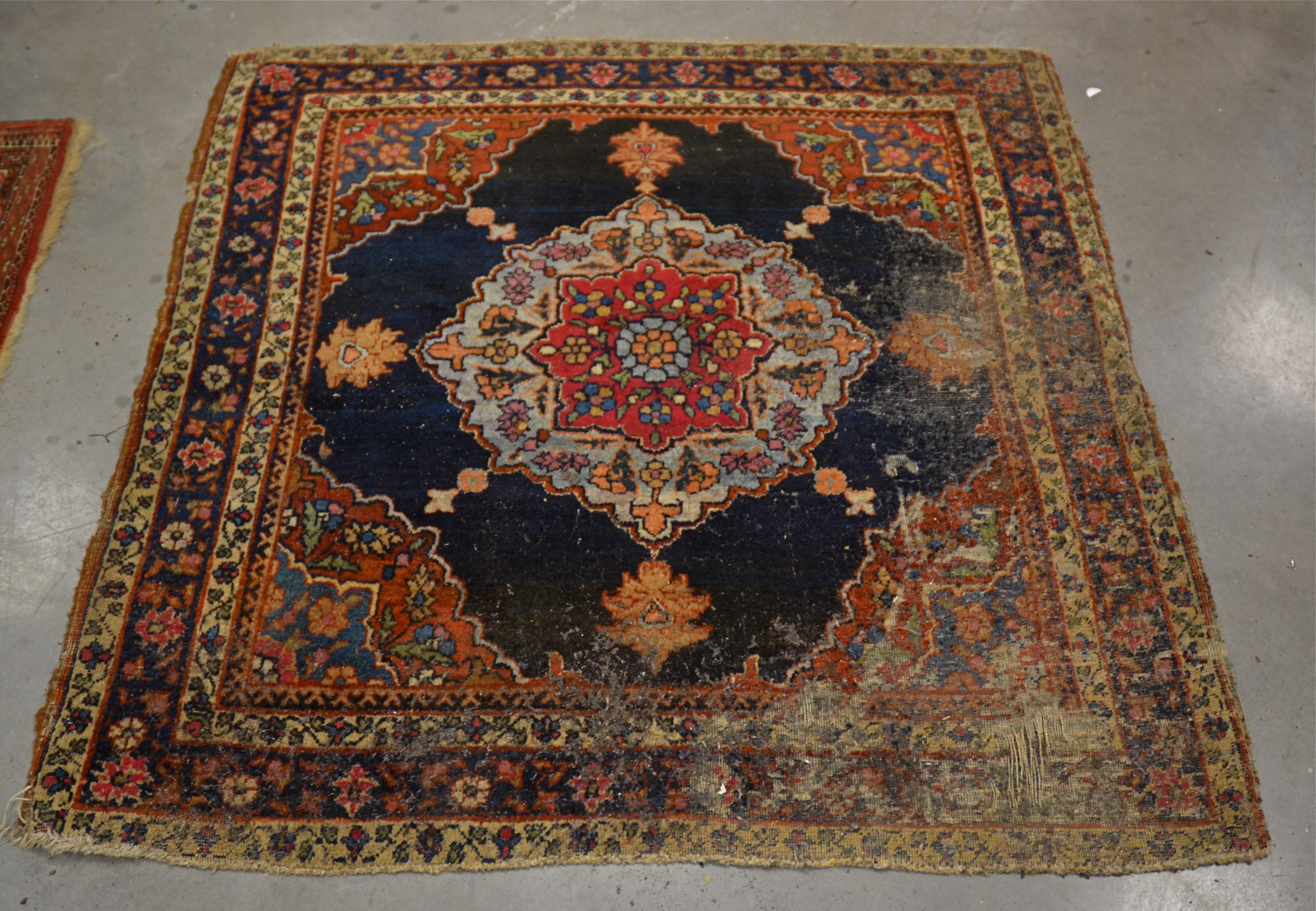 A Middle Eastern rug of near square proportions, with central octofoil shape, surrounded by a