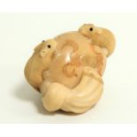 A Japanese Meiji period (1868-1912) or early Taisho (1912 - 1926) ivory netsuke in the form of