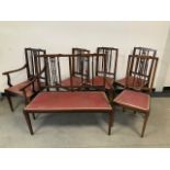 An Edwardian mahogany saloon suite, with inlaid banding and walnut panel, comprising two seater