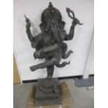 A large copper garden statue of the Hindu deity Ganesh, raised on a square plinth with elephants and