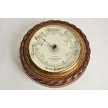 A 20th Century oak circular aneroid barometer, marked 'J. Taylor' '11 Briddlesmith Gate,