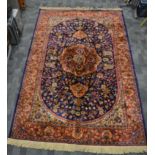 A Sarook Kashan silk rug, the central foliated shape containing alternating floral designs,