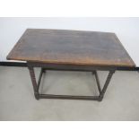 An antique oak cottage table, planked top with cleated ends, raised on bobbin turned supports united