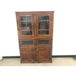 A walnut display cabinet, of rectangular form with two pairs of glazed doors and a pair of panel