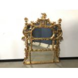 A modern Chinoiserie style gilt wall mirror, some damage to gilding and cracks, 150cm high x 120cm