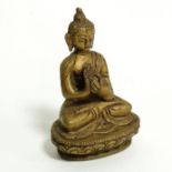 A brass figure of Buddha, seated in the lotus position, height 7.5cm