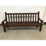 A modern teak garden bench, stained brown, 200cm wide