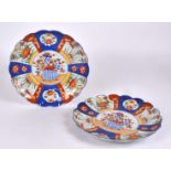 Two Japanese Imari floriform plates, with central design of flowers in a basket, diameter 31cm (2)