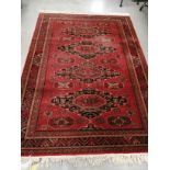 A Belgian Royal Keshan rug, on a red ground with four foliated shapes containing octagons, with