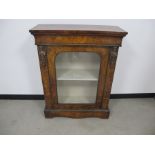 A 19th Century walnut veneered and marquetry inlaid cabinet, single glazed door, upholstered