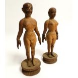 A pair of South Asian softwood figures, being nude male and female raised on a lotus base, the
