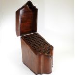 A late 19th or early 20th Century serpentine mahogany knife box, opening to reveal compartments