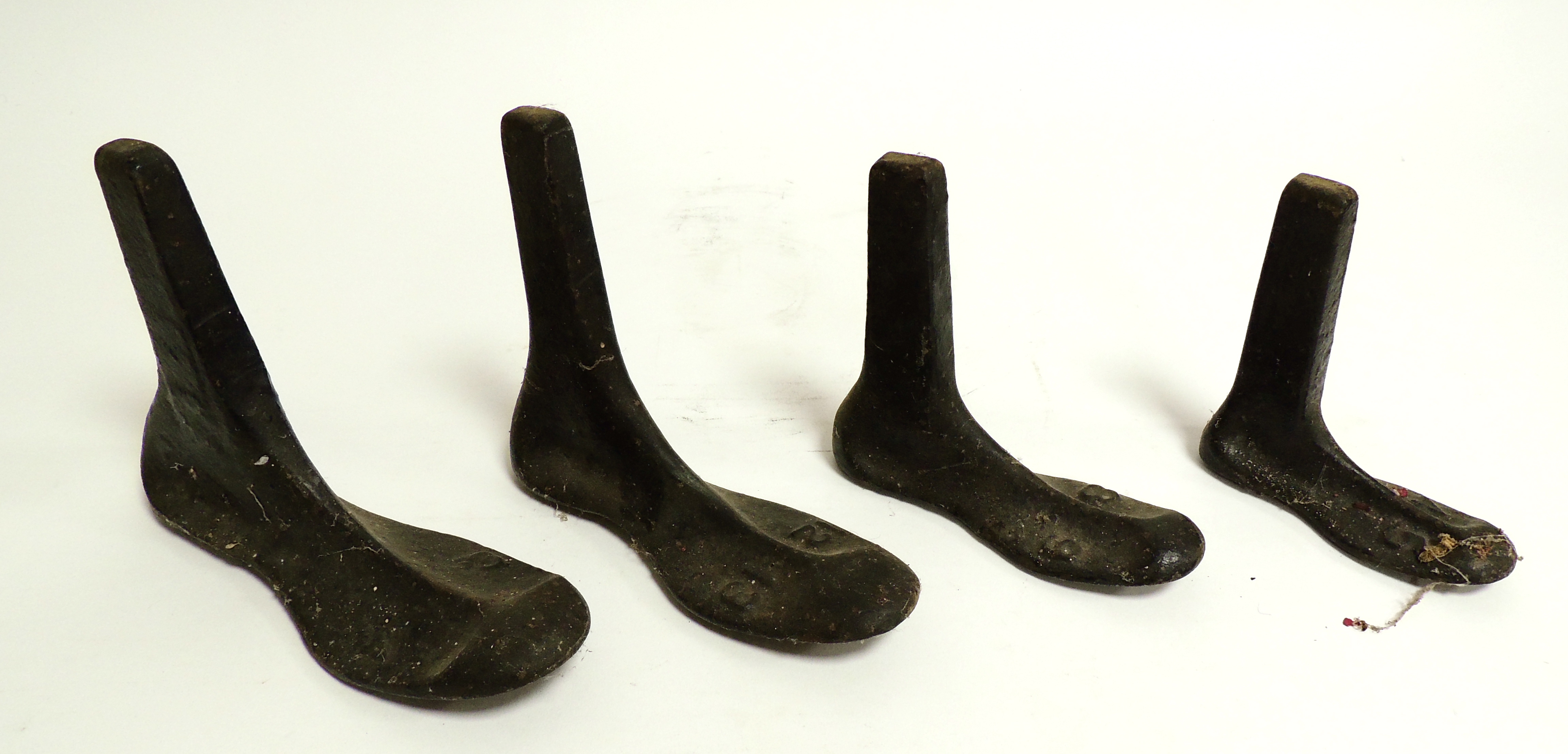 Four cast iron shoe lasts, in graduated sizes, possibly from a cobblers, the largest 23cm (4)