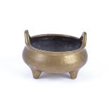 A Chinese bronze tripod censer, of compressed globular body supported on three tapering feet with