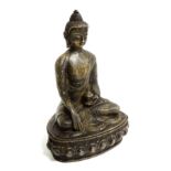 A Chinese bronze figure of Buddha, seated cross legged, raised on a lotus pedestal base, height 21.