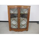 A Georgian mahogany wall hanging corner cupboard, shaped pediment, astragal glazed doors with