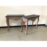 A pair of contemporary Louis XV style console side tables, with black painted tops and destressed