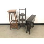 Three pieces of furniture, including an Arts & Crafts plant stand, a later folding cake stand and