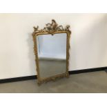 A modern rococo style gilt wall mirror, 117cm x 68cm