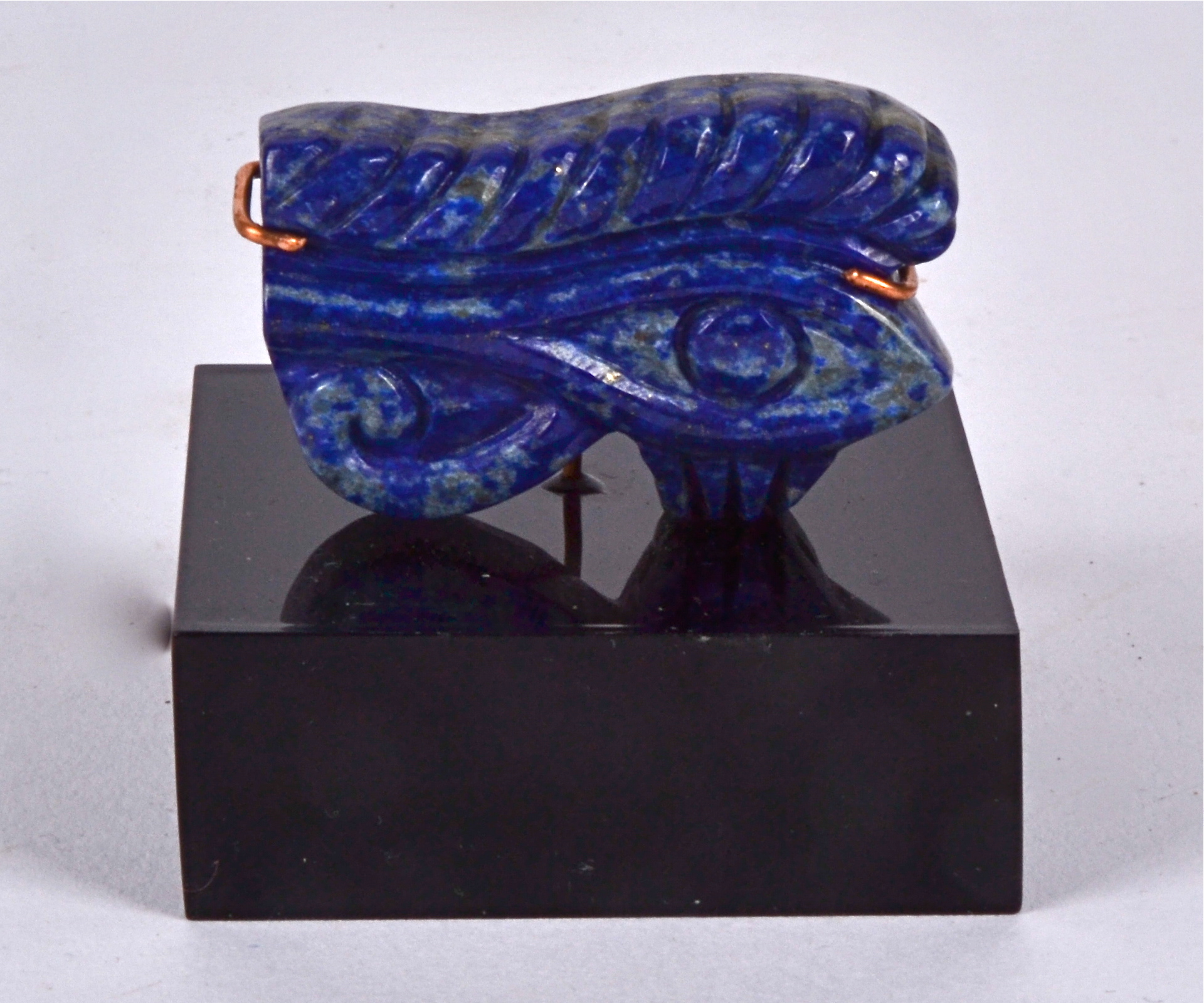 A Lapis Lazuli block mounted on contemporary stand, in the form of an archaic Eastern motif,