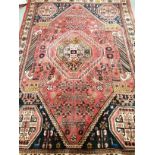 A Middle Eastern Qashqai rug, the central foliated shape surrounded by geometric border and four