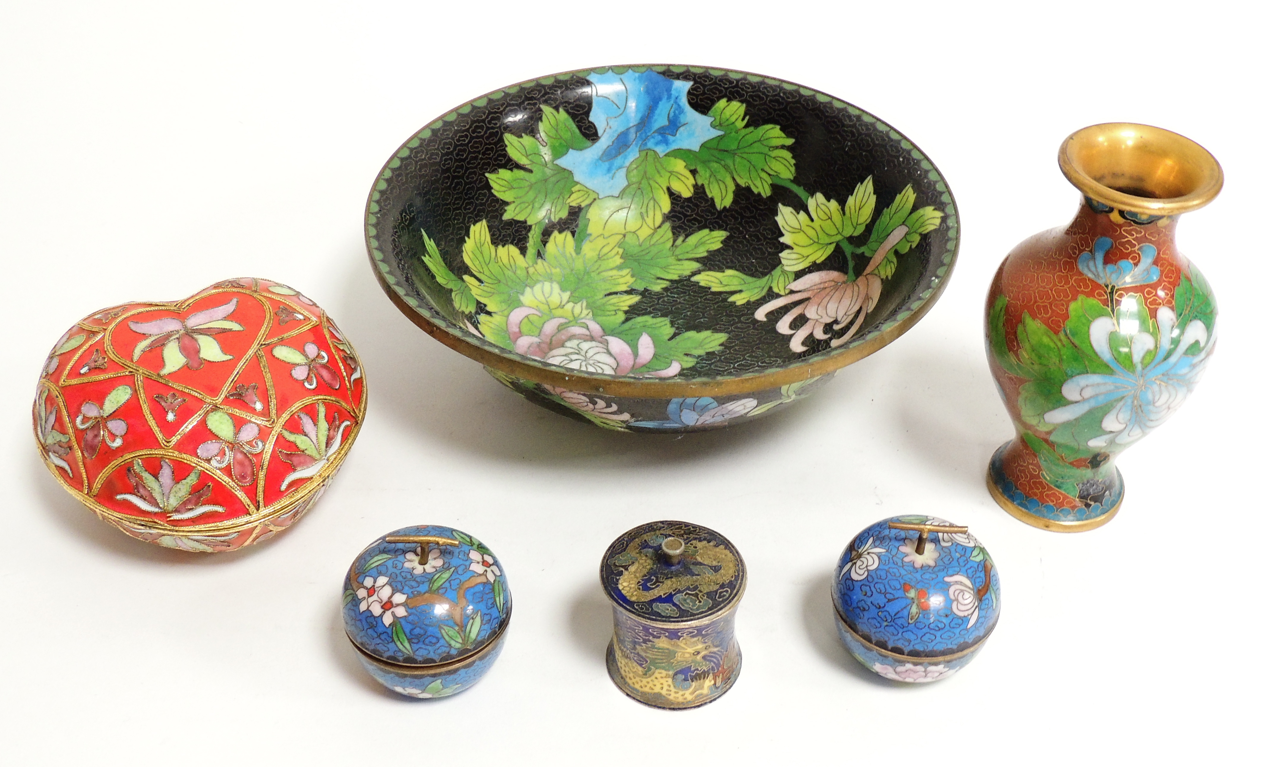 A cloisonné footed bowl, decorated with butterflies and pink flowers against a black ground, 21cm