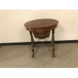 A late Victorian walnut veneered and inlaid sewing table, with fitted interior below oval hinged