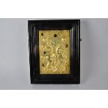 A gilt Russian icon inset with semi-precious stones including turquoise, it's subject a rider on