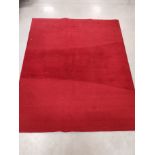 A bespoke woollen red ground rug, the verso with label 'Kappa Lambda Rugs London design Custom