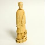 A Chinese marine ivory carving of a lady with an umbrella, probably walrus, with a young child and