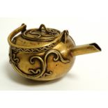 A Chinese bronze teapot on triform feet, of squat form, the sides with mythical beasts in archaistic