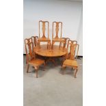 A contemporary oak circular pedestal table and eight matching dining chairs by Alan Solly of