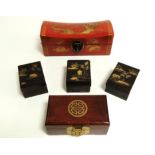 Three Chinese black lacquer boxes each with gilt enamelling of buildings and rocky islands, 11cm x