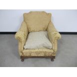 A low upholstered arm chair, stained beech frieze and cabriole front supports, loose drop in cushion