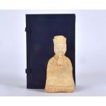 A Chinese tomb style figure, taking the form of a seated male, contained within a case, there