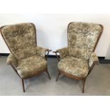 A pair of Ercol armchairs, with floral upholstered seat, back and arms