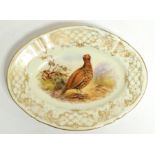 A 19th Century Royal Worcester oval plate, painted with a study of a pheasant with a gilt