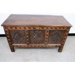 An antique oak panelled coffer, hinged plank top, the front having diamond shape carvings to