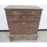 A two piece antique oak chest, the top section having a dovetailed top with moulded edge and five