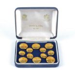 Twelve 20th Century gilt coloured blazer buttons in a Firmin & Sons case, in two sizes, all with a