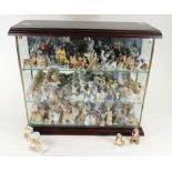 A large collectors' cabinet filled with Wade Whimsies, the figure including Disney figures such as