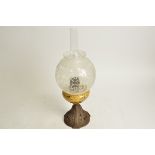 An English cast iron and glass oil lamp, height without shade 23cm