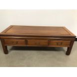 A modern teak Chinese influence coffee table by Brights of Nettlebed, with three drawers, 122cm