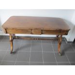 A Regency rosewood centre table, rounded cross banded top, with boxwood stringing, two short