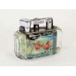 A Dunhill chrome plated and Lucite aquarium table lighter, one side with angel fish, the other