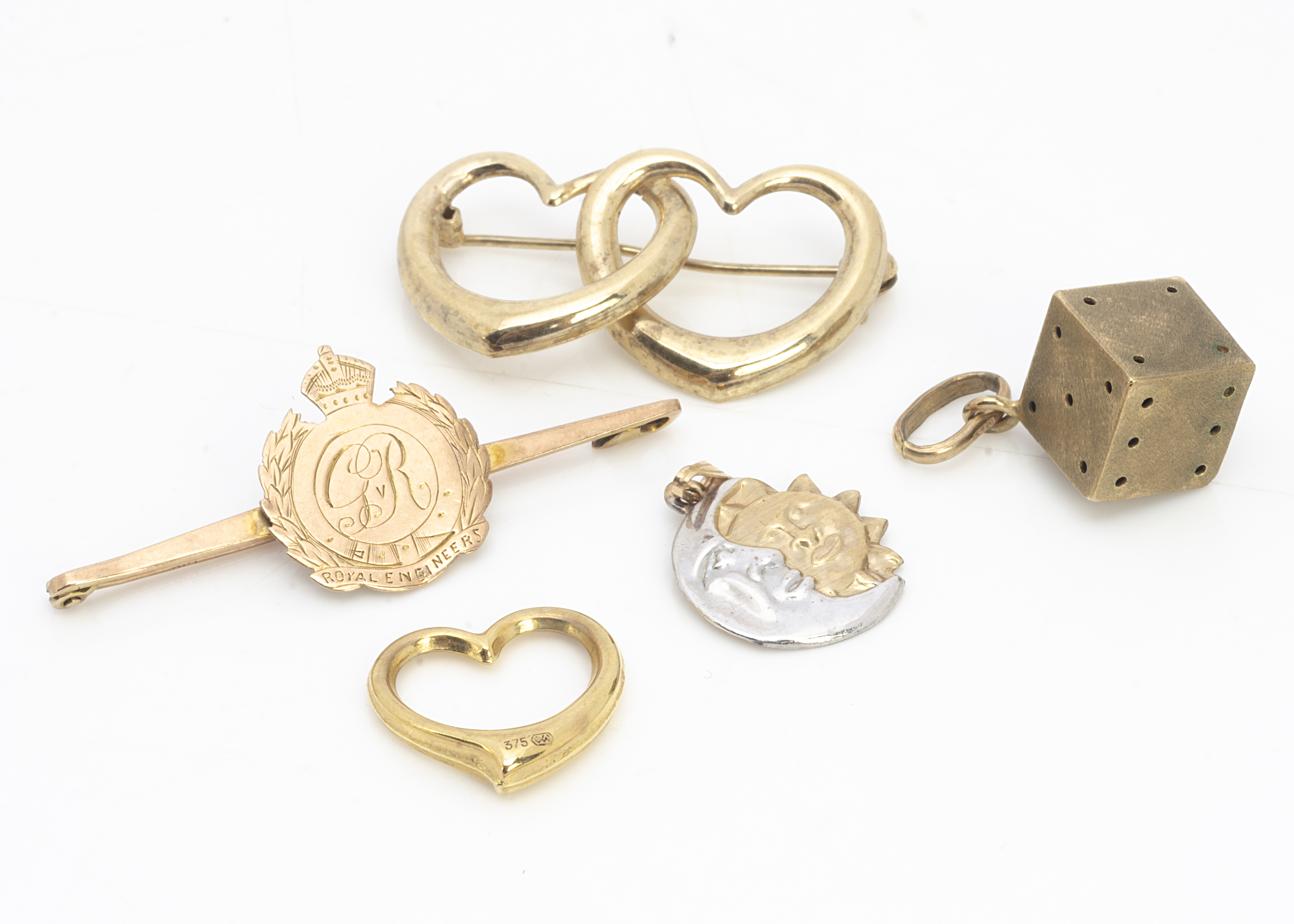 A collection of gold brooches and charms, including a 9ct gold sweetheart George V Royal Engineers