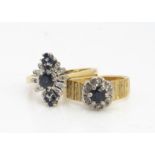 Two 18ct gold sapphire cluster rings, claw set surrounded with eight cut diamonds, both with